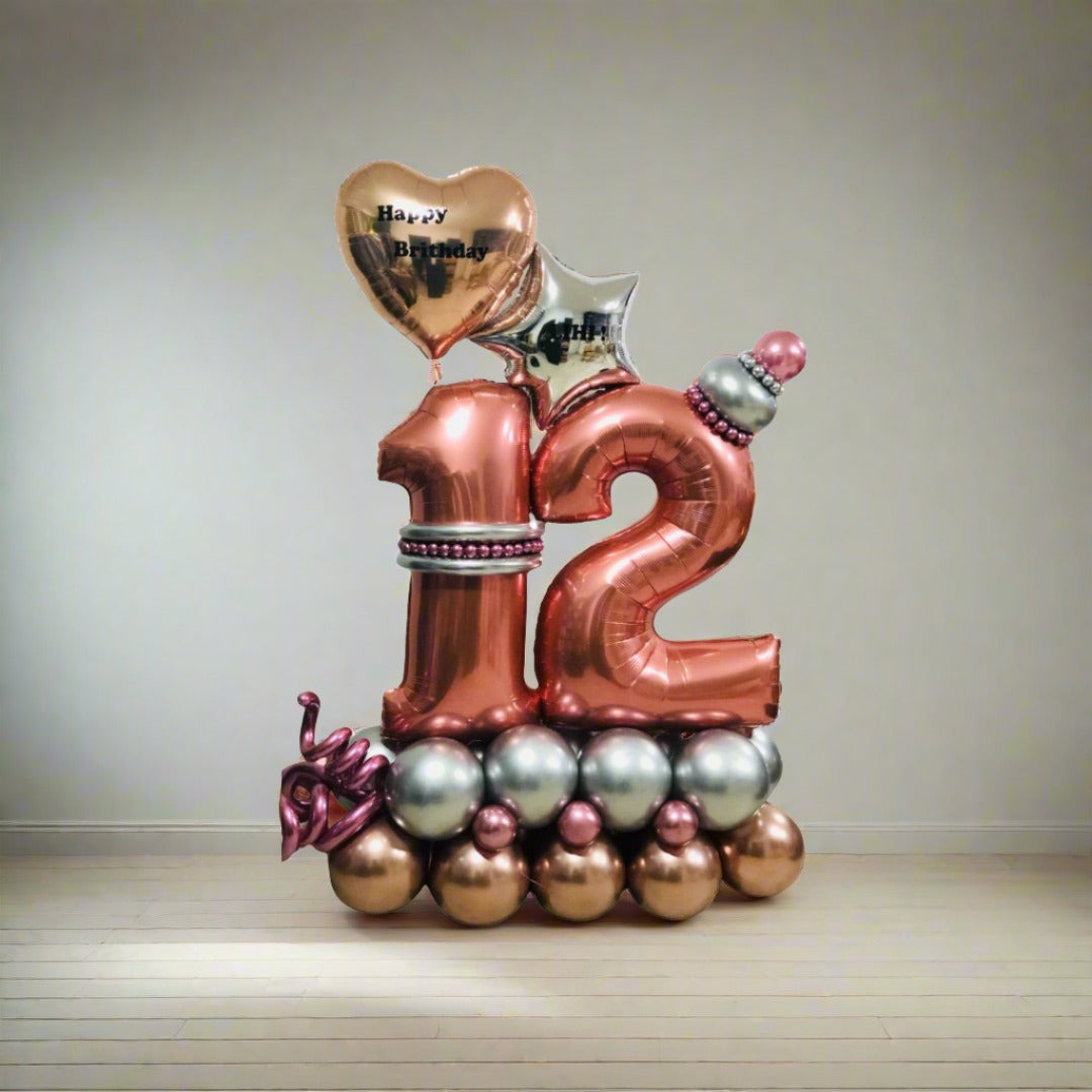 Golden Heart Celebration balloon display with metallic gold and pink balloons and a personalized heart.