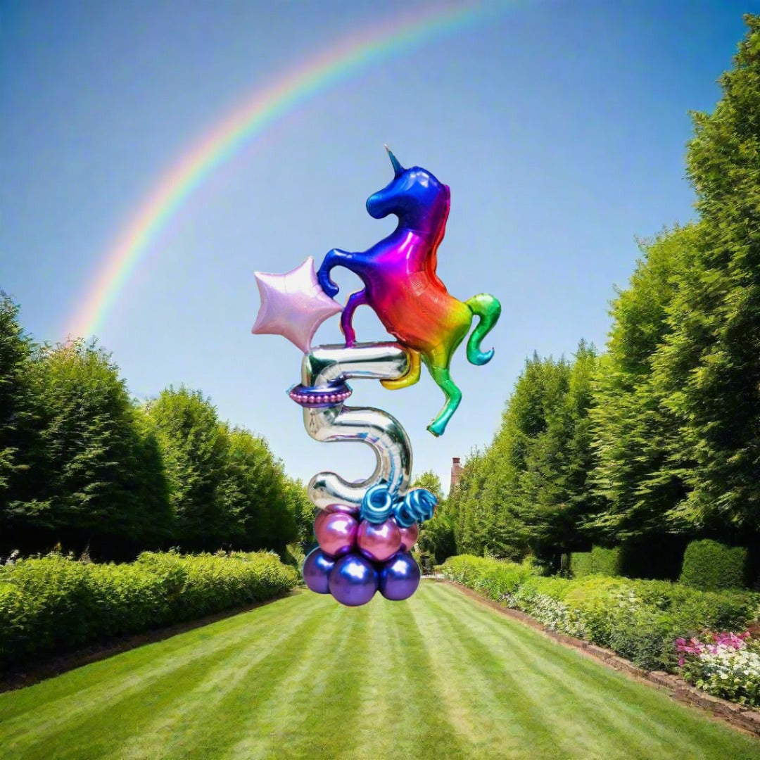 Whimsical unicorn balloon display featuring stars and rainbow colors for fantasy-themed parties.