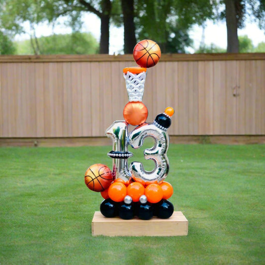 Hoop Dreams balloon display featuring a basketball hoop and star-themed elements for sports-themed events.