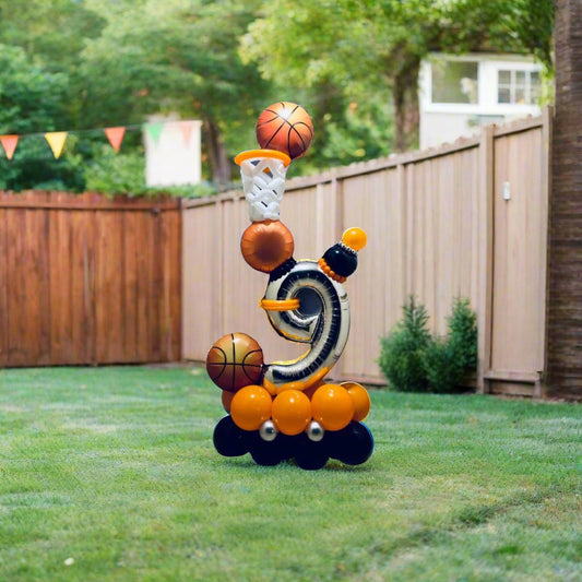 Basketball-themed birthday balloon arrangement with hoop and sports accents.