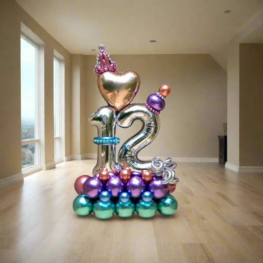 Birthday Royalty balloon display with a gold crown, personalized centerpiece, and blue and purple accents
