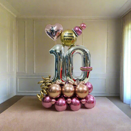 Golden Celebration balloon arrangement featuring metallic gold and pink balloons with personalized messages.