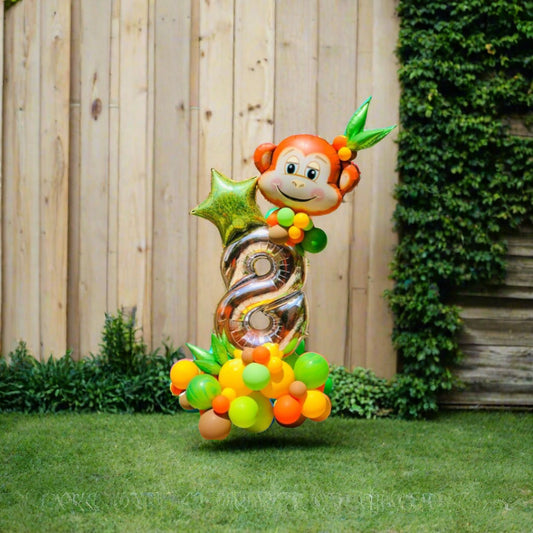 Jungle Joy balloon display featuring a playful monkey, star, and custom number with green and orange balloons.