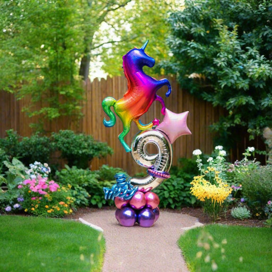 Rainbow Unicorn balloon display with vibrant colors, star accents, and custom number.