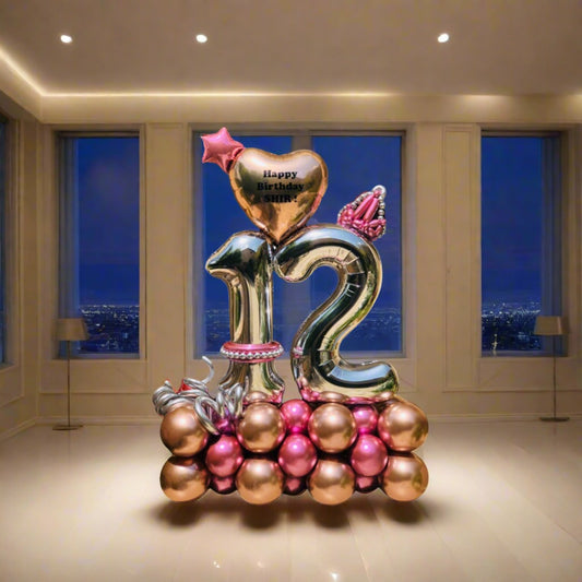 Royal Heart Celebration balloon arrangement featuring a heart, crown, and pink and gold metallic balloons